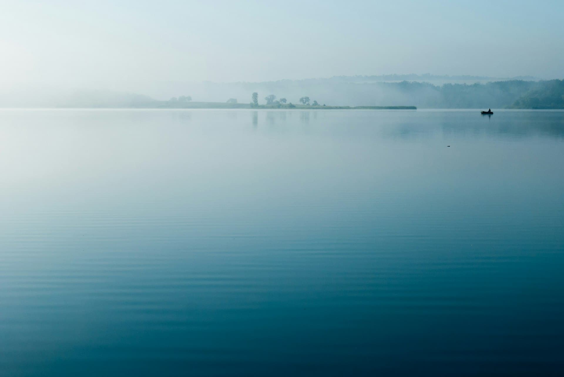 Still, mist-covered water at dawn